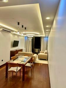 a living room with a table and a couch at The Crescat Suite by Cinnamon Grand in Colombo