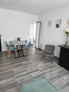a dining room with a table and chairs and a glass table at Appart 1 bray dunes Minouche in Bray-Dunes