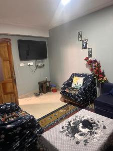 a living room with a couch and a flat screen tv at Karma homestay in Ravangla