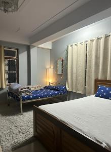 a bedroom with two beds and a blue mattress at Karma homestay in Ravangla