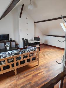 a living room with a table and a dining room at Appart 3 sous combles in Bray-Dunes