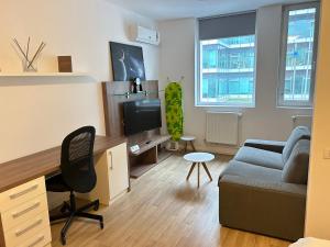 a living room with a couch and a desk at Studio Pompeiu in Bucharest