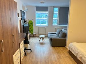 a small living room with a couch and a bed at Studio Pompeiu in Bucharest