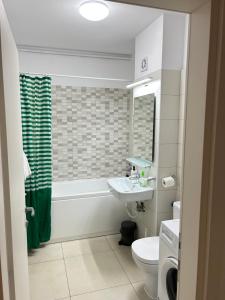 a bathroom with a sink and a tub and a toilet at Studio Pompeiu in Bucharest