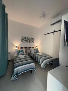 a bedroom with three beds in a room at B&B RoseMary in La Maddalena +5 photos