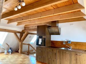 a kitchen with wooden ceilings and a stove at Gemütliche Landhauswohnung in Bad Saulgau +24 photos