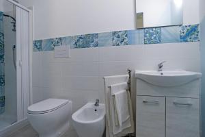 a bathroom with a toilet and a sink at B&B RoseMary in La Maddalena