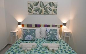 a bedroom with a bed with two night stands at B&B RoseMary in La Maddalena