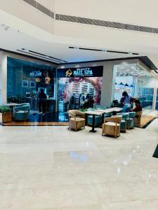 a lobby of a mall with chairs and tables at The Crescat Suite by Cinnamon Grand in Colombo