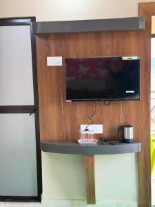a tv on top of a wall with a table at Palashbhumi Resort in Barhanti +16 photos