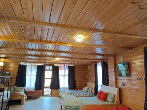 a room with a wooden ceiling with two beds at Ratnagiri Boutique Hotel in Mirik