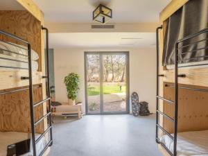 a room with bunk beds and a door to a yard at HEJMO Hostel in Hossegor