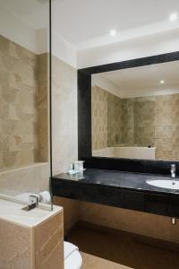 a bathroom with a sink and a mirror at Beau Site Hotel in Marsa Matruh +79 photos
