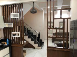 a living room with a staircase and a stair case at Vadodara Homestay in Vadodara +2 photos