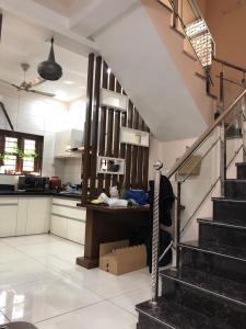 a kitchen with a staircase in a house at Vadodara Homestay in Vadodara