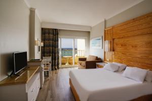 a hotel room with a bed and a television at Beau Site Hotel in Marsa Matruh