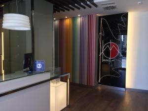 a room with a colorful curtain and a desk at Hotel Boutique Museo Burgos in Burgos