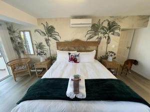 a bedroom with a large bed with a dog in it at The Windsock in Ballito