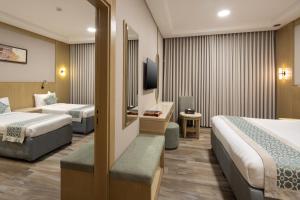 a hotel room with two beds and a television at فندق عفراء in Mecca +180 photos