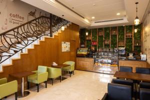 a restaurant with a staircase and tables and chairs at فندق عفراء in Mecca