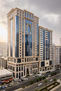 a large building with cars parked in a parking lot at فندق عفراء in Mecca