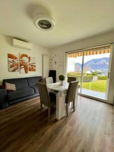a living room with a table and a couch at BADIA del LAGO CLUSANE in Clusane sul Lago