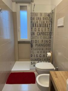 a bathroom with a white toilet and a shower at BADIA del LAGO CLUSANE in Clusane sul Lago