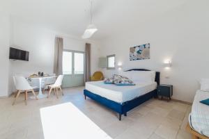 a bedroom with a bed and a table and chairs at Dimora Stune in Ostuni