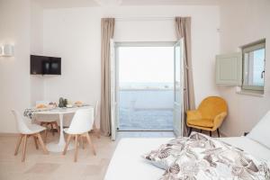a bedroom with a bed and a table and chairs at Dimora Stune in Ostuni +71 photos