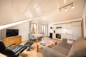 a living room with a couch and a table at Gästehaus Annabell in Nesselwang
