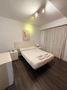 a bedroom with a bed with two towels on it at Zerka Centro in Valencia