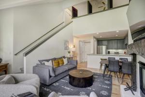 a living room with a couch and a table at Lodge at Brookside, A Vail Resorts Property in Avon