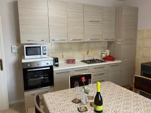 a kitchen with a table with a bottle of wine at La Terasa del Cichino in Roe
