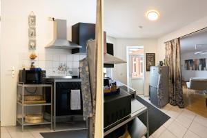 a kitchen with a stove and a refrigerator at City Pension in Reichenbach im Vogtland
