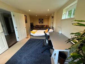 a bedroom with a bed and a desk with a desk at Riverview Colchester in Colchester +6 photos