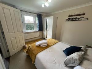 a bedroom with a large bed and a window at Riverview Colchester in Colchester