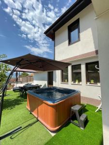 a hot tub in the backyard of a house at Kassandrova Guest House & Spa in Bratsigovo