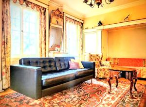 a living room with a leather couch and a table at Ferienhaus Dr. Müller in Meißen +33 photos
