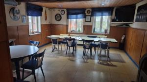 a dining room with tables and chairs and a tv at Monteurzimmer 1 in Frielendorf