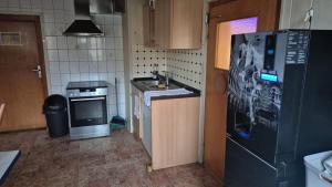 a small kitchen with a sink and a refrigerator at Monteurzimmer 1 in Frielendorf