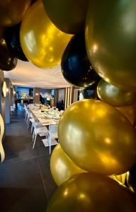 a room with a bunch of gold and black balloons at Hotel Miramare in Sottomarina +77 photos