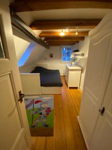 a small attic room with a bed and a desk at Frihmess in Bensheim