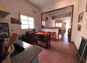 a kitchen with a table and chairs in a room at Casita Eureka in San Antonio de Areco