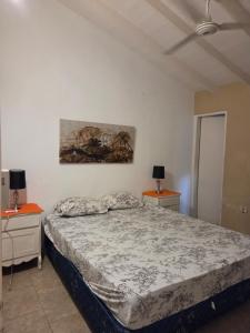 a bedroom with a bed and two night stands at Los Prados Sanber in San Bernardino +2 photos