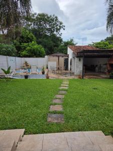 a yard with a stone path in front of a house at Los Prados Sanber in San Bernardino