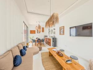 a living room with a couch and a table at Marram Villas 3 Prime Location in Paje