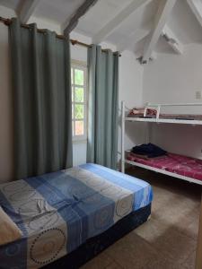 a bedroom with a bed and a window at Los Prados Sanber in San Bernardino