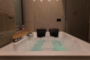 a bath tub with two chairs in it at Sardinian Days - Suites & Rooms in Cagliari