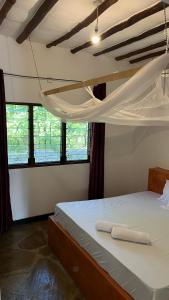 a bedroom with a bunk bed with two towels on it at 2 Bedroom serene cottage in Ukunda Airport