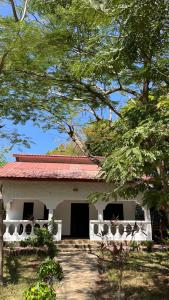 a small white building with a red roof at 2 Bedroom serene cottage in Ukunda Airport